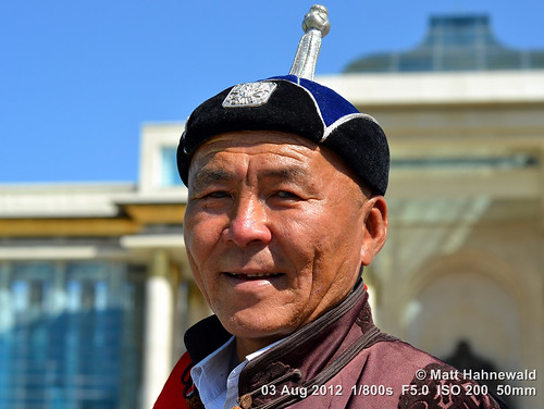 portrait travel smiling ethnic posing cultural character tourism man male hat street eyes asia asian matthahnewaldphotography face facingtheworld chinggiskhaan horizontal head mongolia deel mongolian outdoor ulaanbaatar expression headshot lifestyle 1200x900pixels resized colour colourful clarity person 4x3ratio emotional closeup consensual lookingatcamera