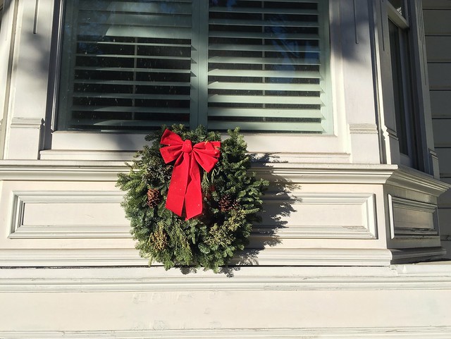 Standard Tree Branch Wreath with Big Red Bow on Window Sill.