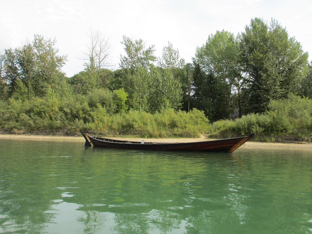 A canoe floating near the shore on the North Saskatchewan River