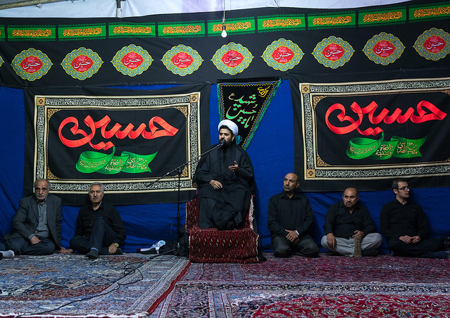 Iranian shiite muslim men listening to a mullah who preaches during muharram, Central county, Theran, Iran