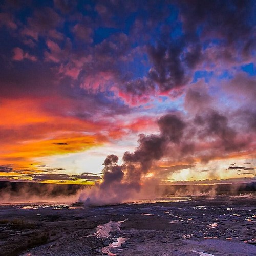 The largest #geyser basin at #Yellowstone #NationalPark, Lower Geyser Basin spans about 18 square miles and includes mud pots, geysers, pools, springs and fumaroles. Stay for #sunset, and you won’t be disappointed. In this picture, sunset paints the sky i | by jewnjoonjune