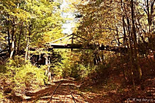 Old wooden bridge over the tracks.