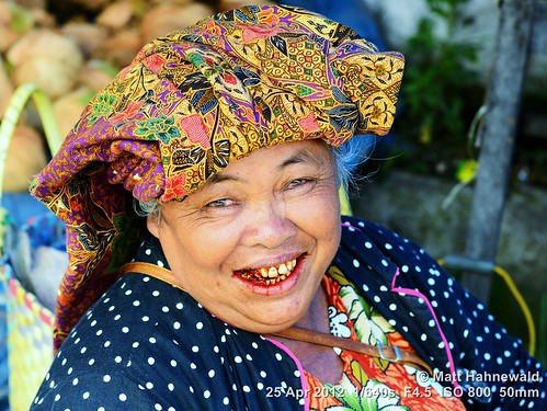 arecanut paan chewingtobacco stainedteeth travel smiling ethnic street portrait cultural character female market posing betelnut eyes face facingtheworld batak indonesia toba woman nikond3100 outdoor sumatra diversity betelstainedteeth lifestyle nikkorafs50mmf18g person closeup fullfaceview matthahnewald headshot colorcolour lookingatviewer colorfulcolourful