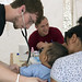 Volunteer Using Stethoscope on Baby