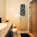 Spa or your own personal bathroom? The stand-up shower with marble tile says spa.      


