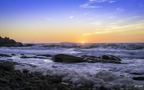 sunset island rocks waves foam