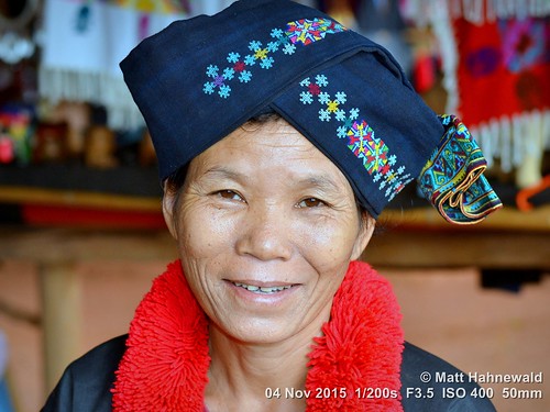 tourism ethnic woman smiling turban primelens portrait cultural character posing mouth lips female blue street asia asian flash matthahnewaldphotography banpaoonanglae face facingtheworld chiangrai hilltribe head nikond3100 outdoor red traditional travel yao 50mm lumien northern headshot embroidery nikkorafs50mmf18g fullfaceview colour colourful person emotional closeup consensual lookingatcamera