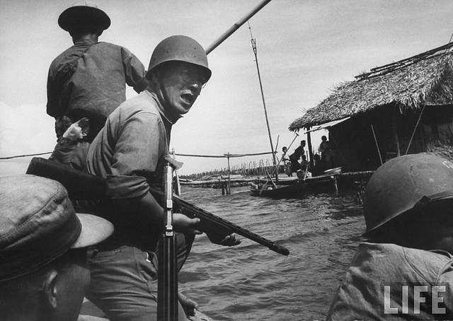 Father Nguyen Lac Hoa fighting in the Vietnam War while still preaching church services -  by HOWARD SOCHUREK 12-1962