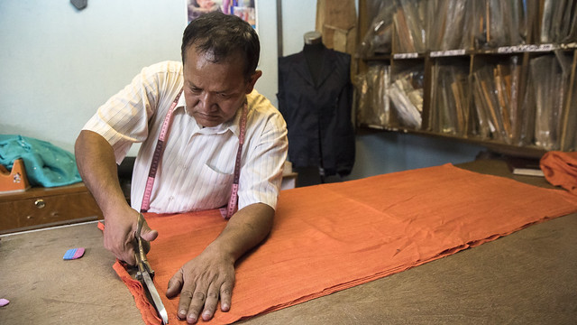 Man Works on Fabric
