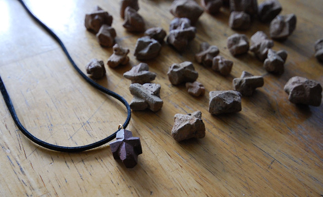 Here is a polished fairy stone on a leather cord as well as raw fairy stones from Fairy Stone State Park in Virginia