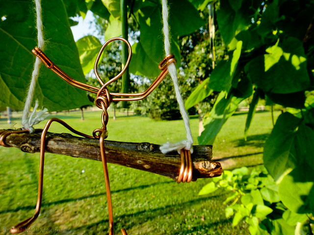Get into the swing of Winnemac Park (wire figure on catalpa tree)