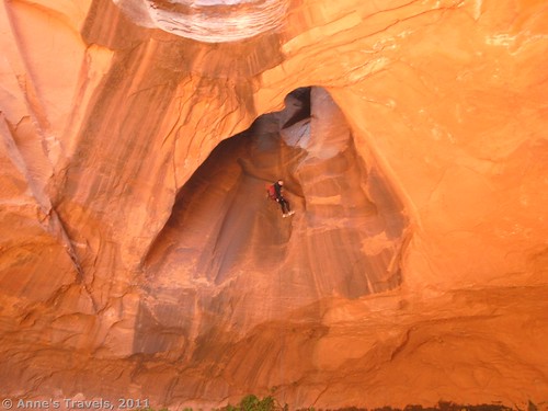 A climber repelling through the pothole in Neon Canyon, Glen Canyon Recreation Area, Utah