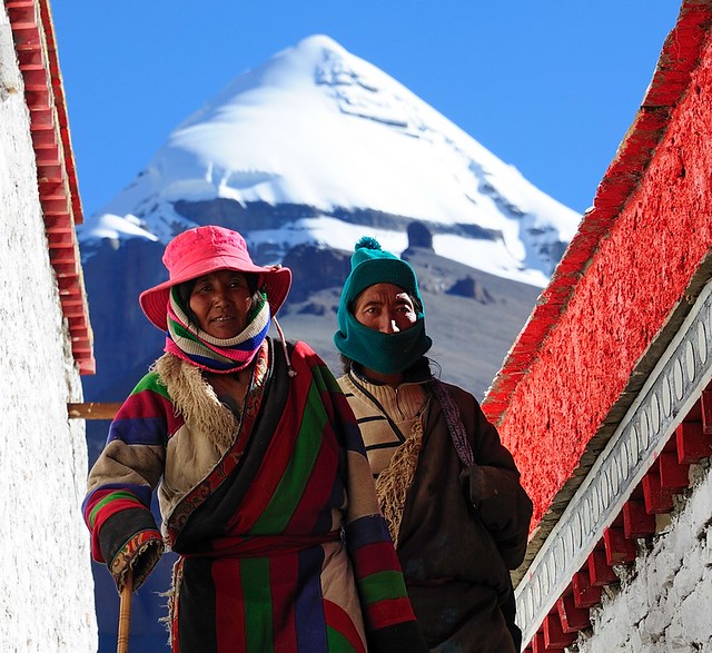 Pilgrims circumambulate the Choku monastery, Mount Kailash in the background. Tibet