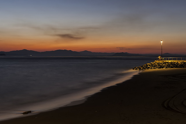 Puntarenas Beach, Costa Rica. Sunset and Long Exposure. A couple in love under the light pole.