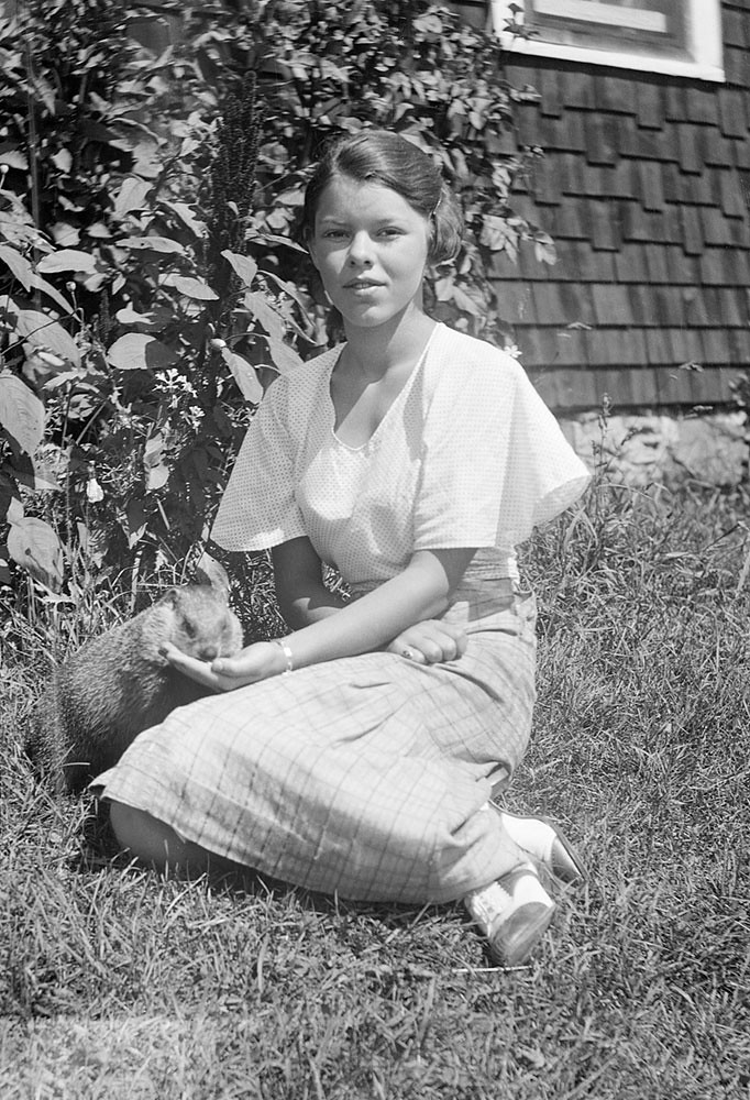 My Grandma back around 1934 with the family pet woodchuck. Moe's River, Quebec. Canada.