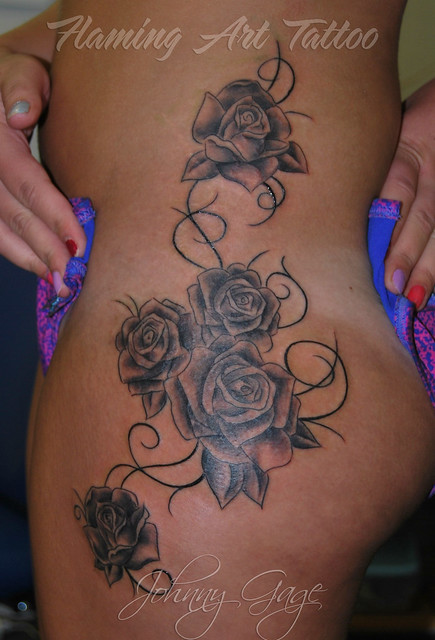 roses on thigh and hip tattoo