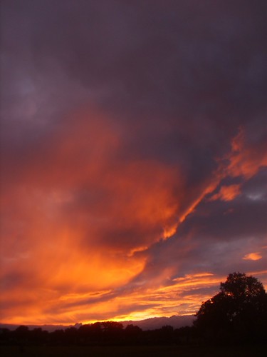 August sunset in rural France by this is nick, A very nice sunset I saw in France. The sun was mostly behind some clouds, but just a sliver peeked 
