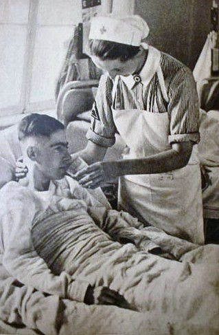 German Red Cross nurse attending a wounded German soldier in hospital