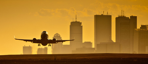 sunset boston skyline plane airport takeoff