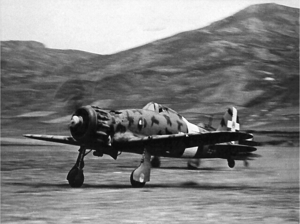 two Macchi C-200 Saetta of the 8th fighter group taking off from airfield in North Africa