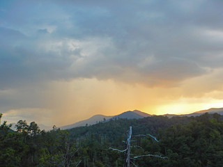 Sun setting behind Hughes Ridge as storm rolls in.