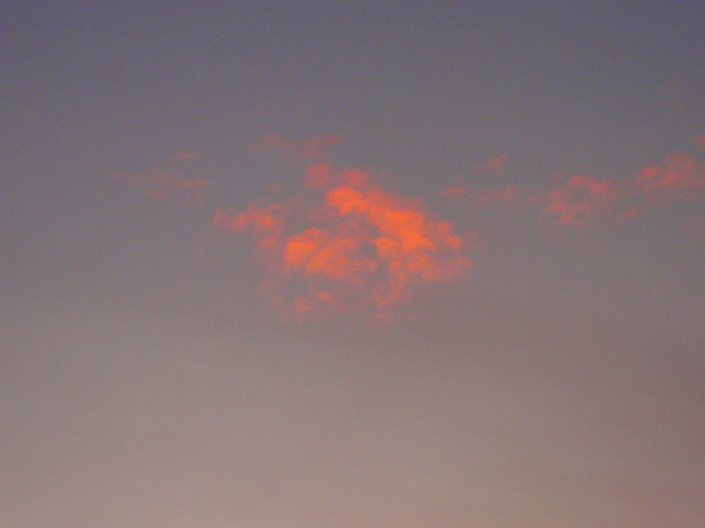 red cloud in grey sky