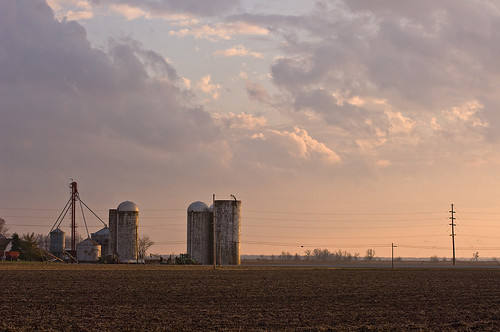 sunset farm silo stormclouds