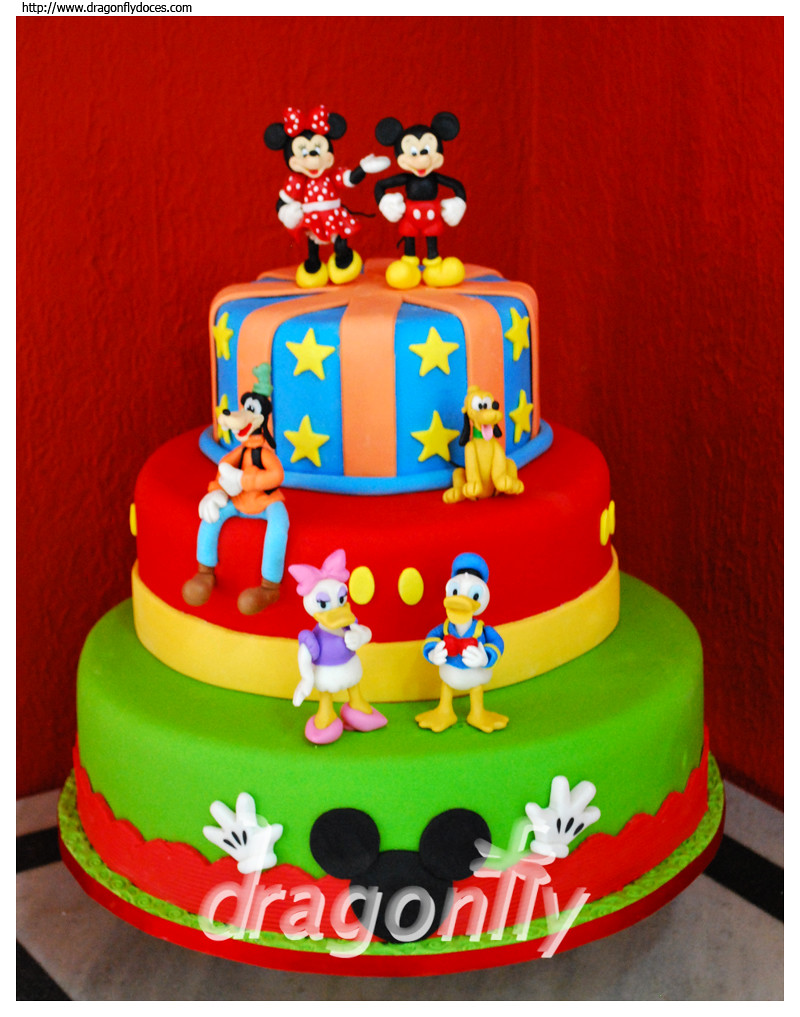 A cake inspired by Disney's characters Mickey, Minnie, Goofy, Pluto, D...