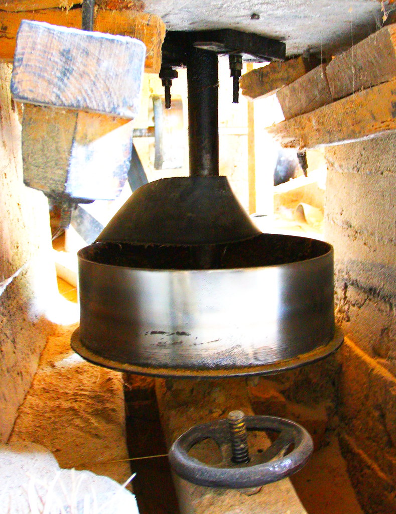 Flour mill drive belt under rotating grinding stone in Kashmir
