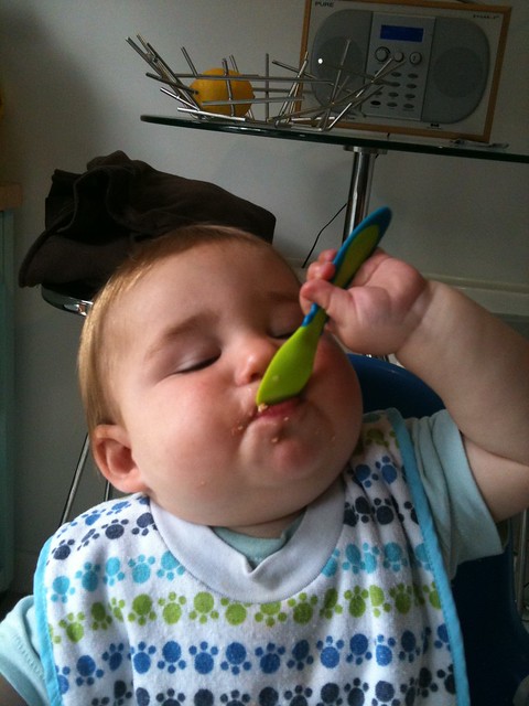 Using a spoon himself for the first time!