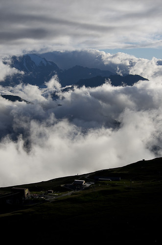 Cloudy by Torbjørn T, Clouds rolling in over Val de Bagnes behind a ski lift in La Chaux, as seen from Cabane Mont Fort