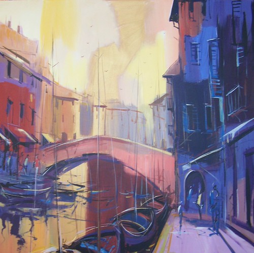 Arched bridge over a canal between tall buildings