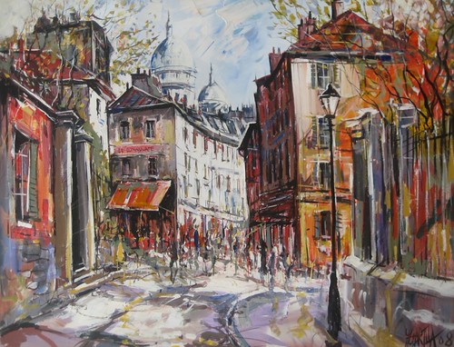 People along a street between tall buildings