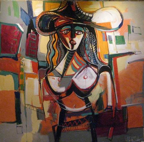 Woman in a broad hat among warm geometric blocks