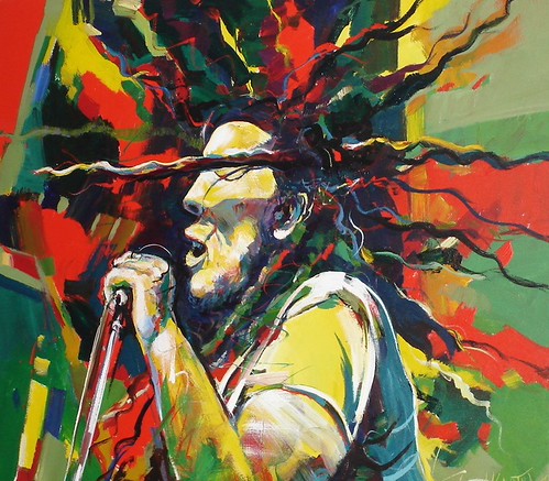 Singer at a microphone with radiating coloured strokes