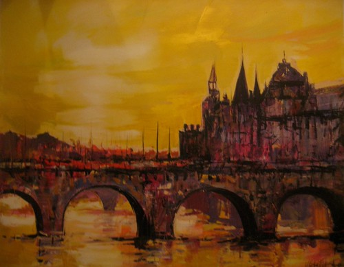 Stone bridge and riverside buildings at golden dusk