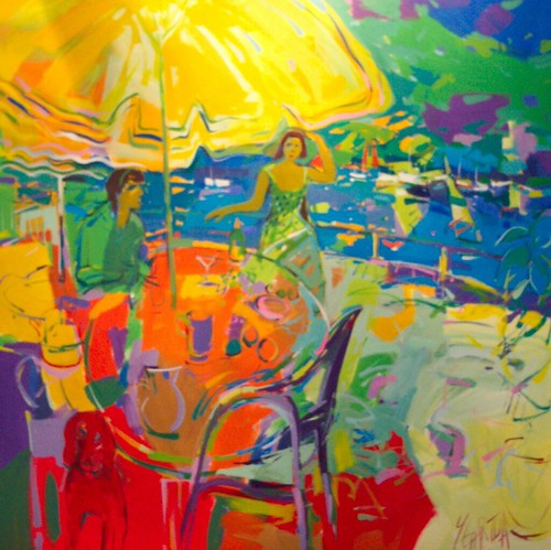 Outdoor tables and figures under a yellow parasol