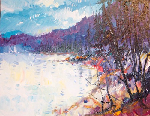 Lake and autumn trees beneath blue sky