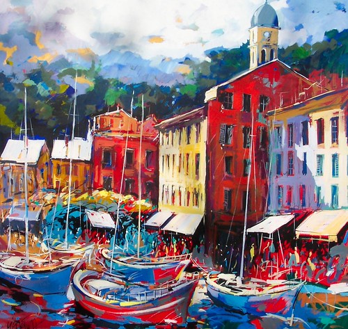 Colourful waterfront houses above boats in a harbour