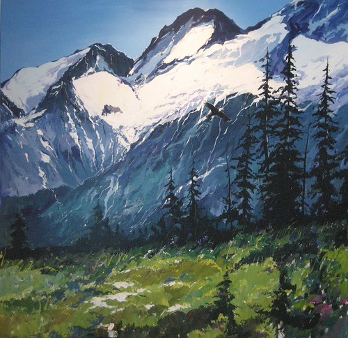 Snow-covered mountain framed by evergreens