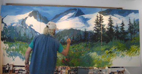 Artist painting a mountain landscape