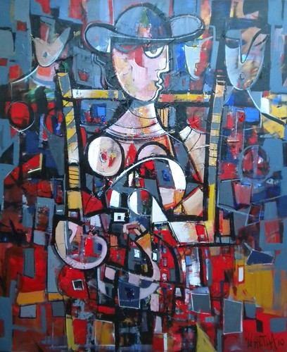 Seated figure surrounded by small angular faces