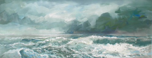 Foaming ocean waves below dark clouds