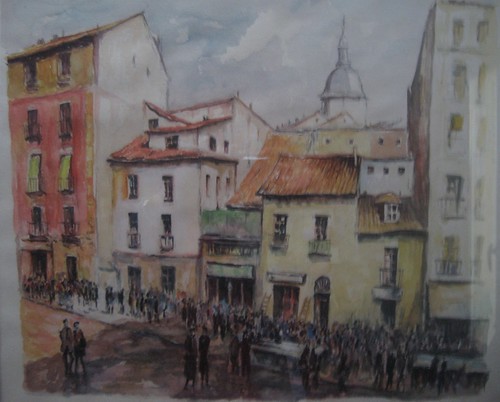 Pale waterfront buildings beneath a distant tower