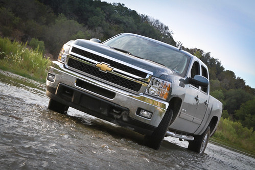 Chevrolet truck driving through muddy water