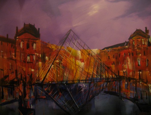 Glass pyramid framed by buildings at dusk