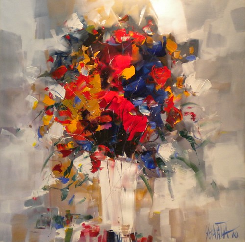 Red and orange flowers in a pale vase