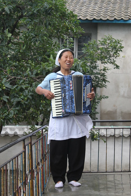 Lady with Accordion at the Chonsam Cooperative Farm North Korea
