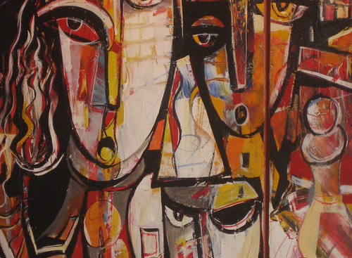 Three large angular faces in cream, red and brown
