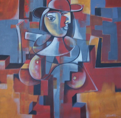 Seated geometric figure against blue and red blocks
